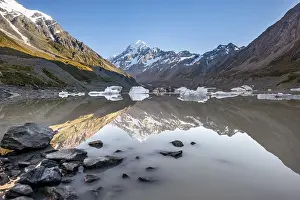 Shore with rocks, reflection in Hooker Lake at sunrise
