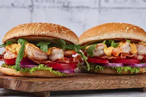 Two shrimp burgers and buns with sesame seeds