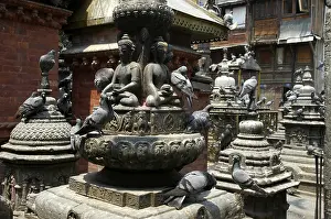 Many shrines and statues with pigeons