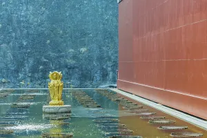 Four sided standing Buddha statue in man made pond at Buddhist temple in Yeongcheon
