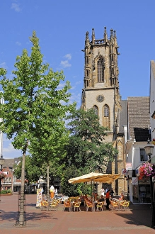 A sidewalk cafe and St. Johannes-Kirche church