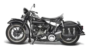 Sideways shot of a vintage motorbike in white back