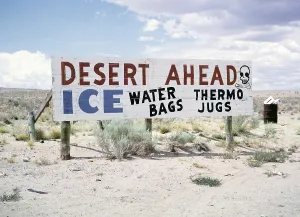 Sign warning of the desert, advert for ice, water bags, thermos flasks, USA 1963