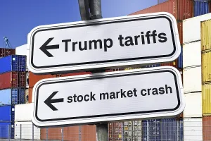 Signposts with the words Trump tariffs and stock market crash in front of stacked containers