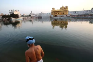 Sikh take dip in lake of Harmandir Sahib or Darbar Sahib or Golden temple in Amritsar