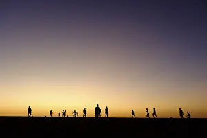 Silhouette of children playing football