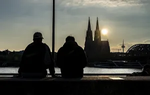 Silhouettes of people, in late sunlight