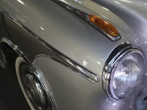 Silver classic car with chrome accents and shiny headlights