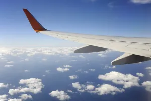 Silver wing, Boeing 737-800 aeroplane flying over the clouds