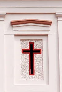The simple Crucifix, the oldest symbol of Christianity colourfully painted on wall of church