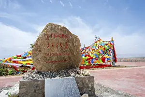 Sing at Caka salt lake and colorful tibetan buddhist praying flags in the wind Chaqia