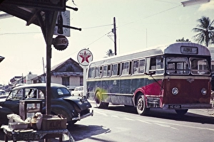 Single-decker country bus at a crossroads in the village of Arima, Trinidad, around 1962