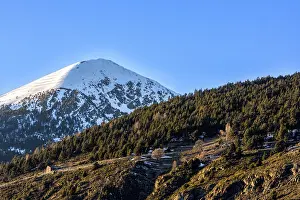Single high mountain with pick in snow
