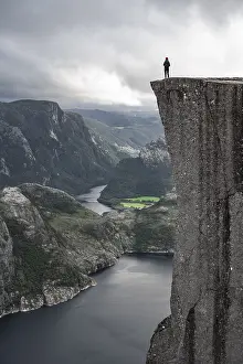Single person on rock plateau, Preikestolen rock spire