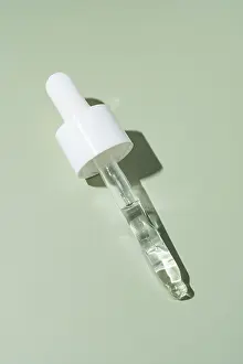 A single pipette dropper filled with a clear liquid