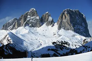 Ski slope at Pordoi Pass and mountain Langkofel in winter