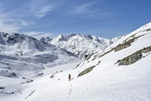 Ski tourer in mountain landscape with snow