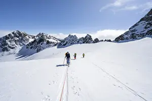Ski tourer with rope, rope team on the Vadret da Porchabella glacier on the ascent to the summit of Piz Kesch