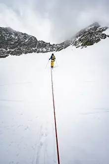 Ski tourers ascending the rope