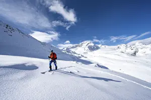 Ski tourers in a snow-covered mountain landscape