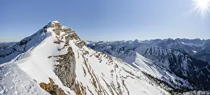 Ski tourers on a snow-covered mountain ridge