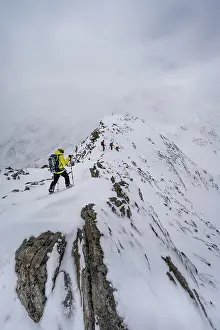 Ski tourers on the summit of the Kollkuppe or Cima Marmota