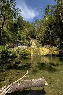 Small bathing lake in the Valle de los Ingenios with tourists