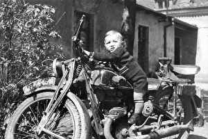 Small child on a motorbike, historical photo