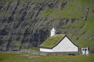 Small church with grass roof in mountain landscape