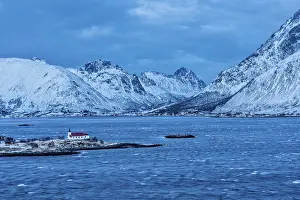 Small church with a red roof on a peninsula