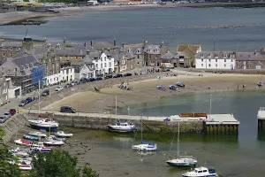 Small harbour with boats and surrounding houses on the coast