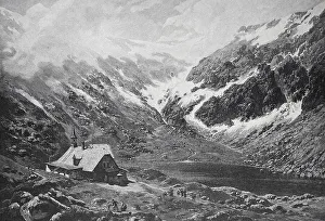 A small hut in a snowy valley, surrounded by high mountains