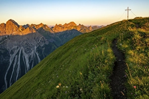 Category Mountain Landscapes Prints: Small mountain trail with flower meadow and summit of the Uentschenspitze at sunrise