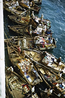 Small open boats in which merchants sell souvenirs and products to the passengers of a ship, Aden, Yemen 1956