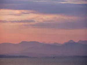 Small sailing boat on the Chiemsee in the morning light