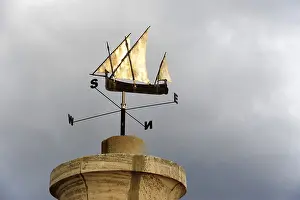 Small sailing boat, wind rose in the harbour