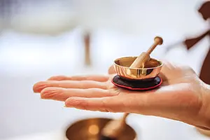 Small singing bowl holding in hand