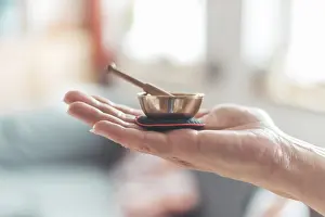 Small singing bowl holding in hand