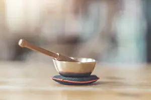 Small singing bowl on a rustic wooden table