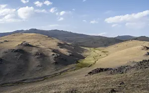 Small stream between mountainous hills