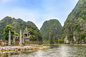 Small temple with forested limestone rocks
