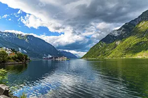 Small town of Odda. Magical late summer sunset illuminates the city and the water