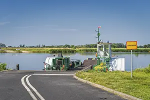 Framed Print : Small, vintage paddle steamer ferry operating on Oder River crossing between Poland and Germany Framed Print : Small, vintage paddle steamer ferry operating on Oder River crossing between Poland and Germany