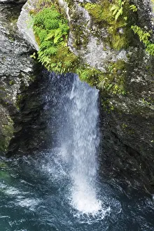 Small waterfall in the mountains of Norway in the summer