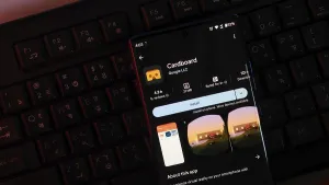 Smartphone displaying Cardboard app interface in dark lighting over a keyboard