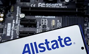 Smartphone with logo allstate insurance company on paper policy and money currency