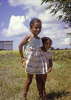Two smiling little girls new citizens of newly independent Trinidad and Tobago c 1962