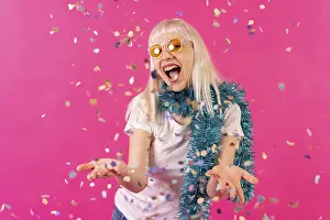 Framed Print : Smiling at a party throwing confetti in sunglasses