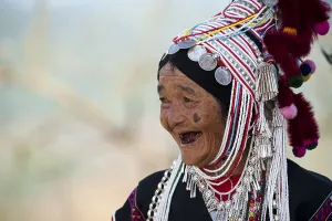 Smiling woman with headdress of the Akha hill tribe