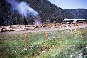 Smoke from a beehive or wigwam burner, sawmill in the Rocky Mountains, New Mexico, USA 1963